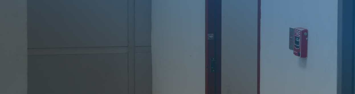 A call point unit near a fire exit door in an office