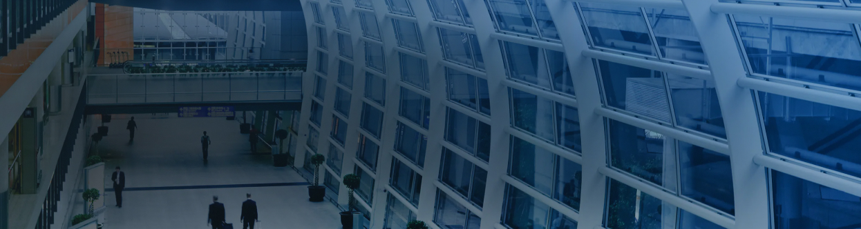 Aerial view of people walking along a passage in an airport